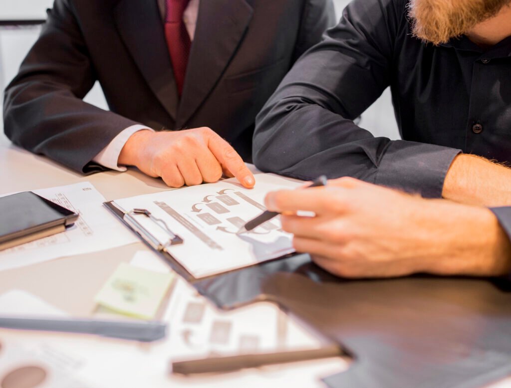 Business owner and advisors discussing deal structure, tax planning, and financial considerations when selling a business in California.