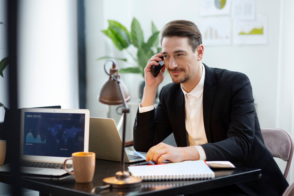“Business broker discussing a potential business sale with a client over the phone”