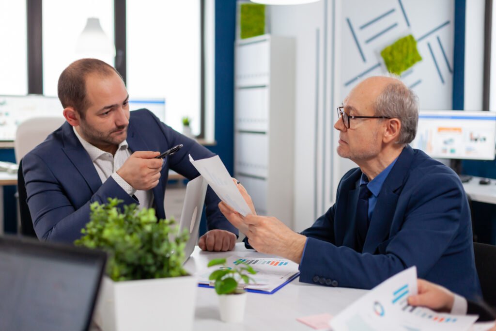 Business owner reviewing financial documents and planning taxes before selling a business, highlighting deal structure and after-tax proceeds.