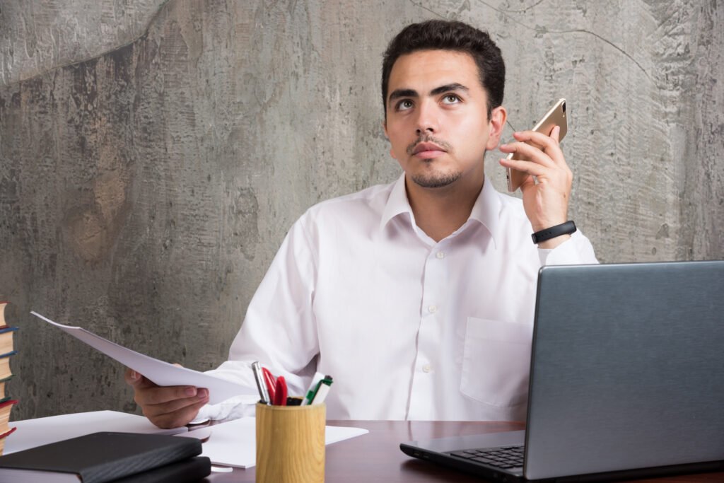Business owner reviewing documents and managing a business sale without professional guidance.